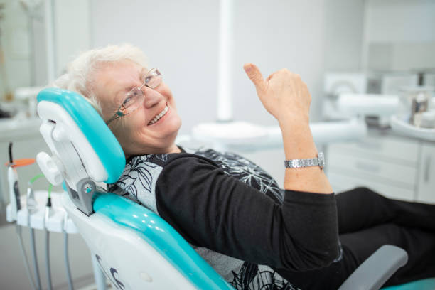 geriatric Women Smiling after an implant treatment