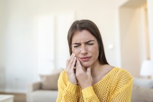 tooth-pain-dentistry-beautiful-young-woman-suffering-from-terrible-strong-teeth-pain-touching-cheek-with-hand-female-feeling-painful-toothache-dental-care-health